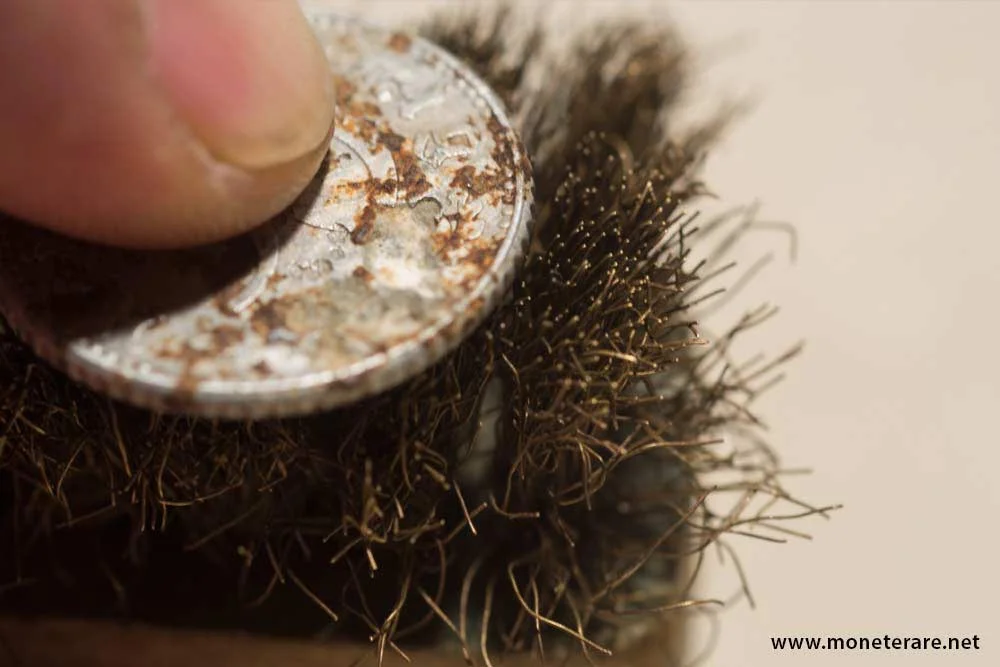 cleaning rare coins with a brush